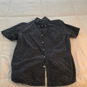 Dark blue button down collared shirt with white flowers.